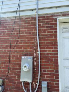 Deshaies Electrical Services installing a residential electrical meter and conduit for efficient power distribution