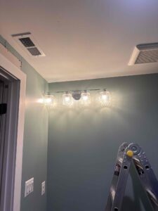 Deshaies Electrical Services installing light fixtures for a basement renovation project