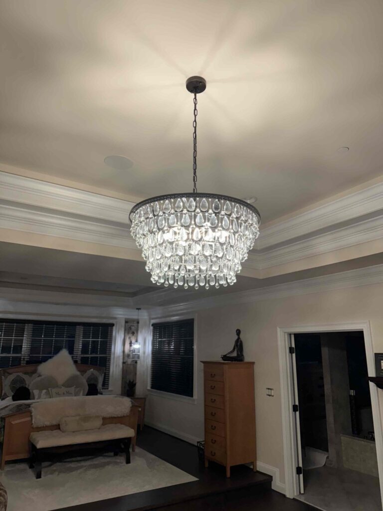 Deshaies Electrical Services installing a chandelier as part of a comprehensive residential lighting upgrade