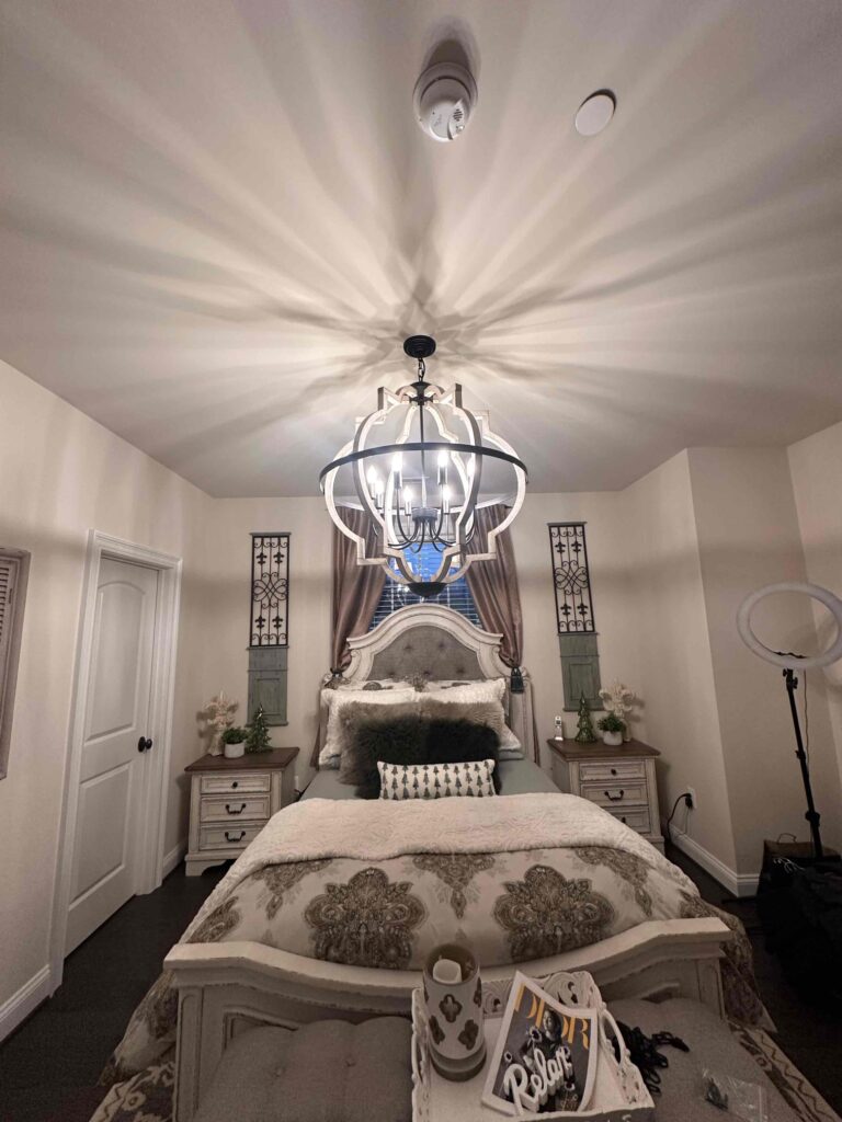 Deshaies Electrical Services performing a light fixture replacement in a residential bedroom