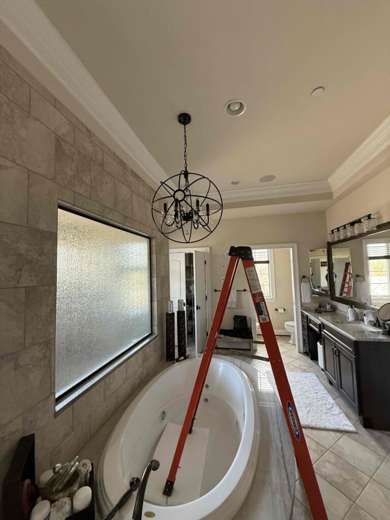 Deshaies Electrical Services preparing to install new lighting fixtures in the bathroom as part of Tiffany's refurbishment project