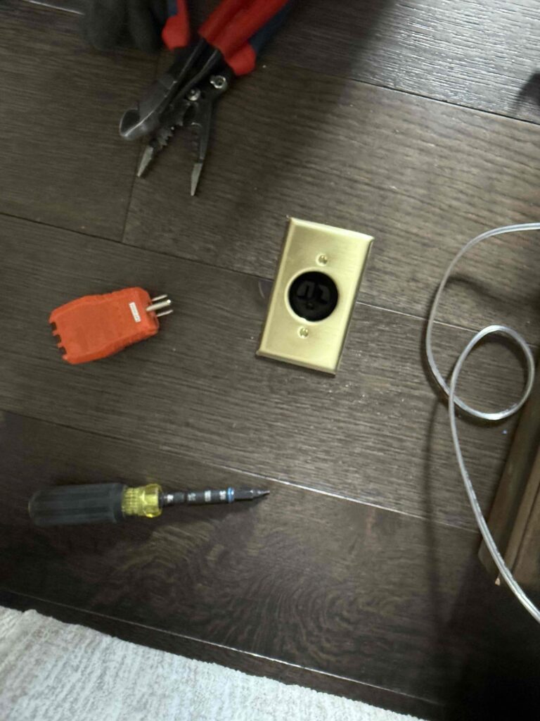 Deshaies Electrical Services upgrading a floor outlet for wall sconce installation