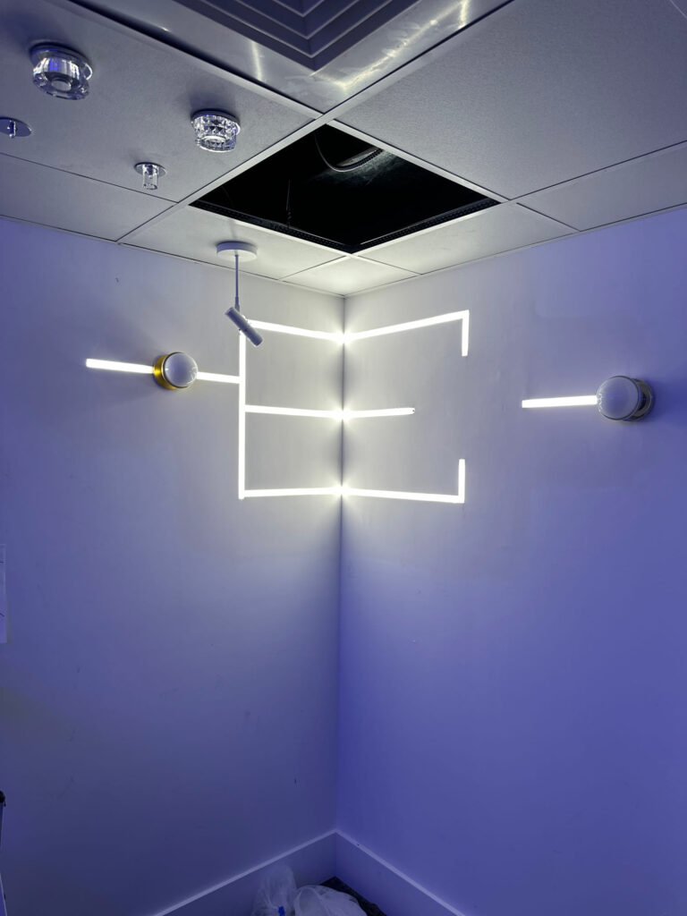 Deshaies Electrical Services completing installation of modern LED light fixtures and switches in the workspace