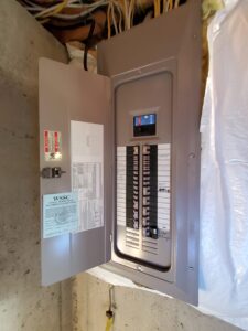 Deshaies Electrical Services inspecting the electrical panel for EV charging outlet installation