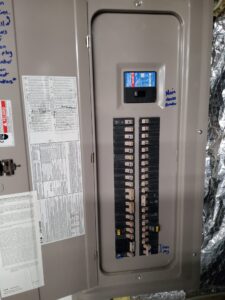 Deshaies Electrical Services inspecting the main electrical panel for porch ceiling fan installation and switch setup