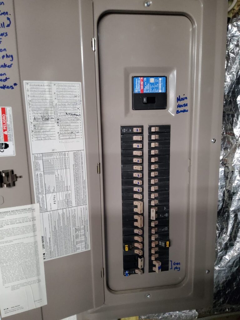 Deshaies Electrical Services inspecting the main electrical panel for porch ceiling fan installation and switch setup