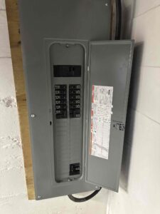 Deshaies Electrical Services installing a circuit breaker panel for HVAC system wiring from basement to attic