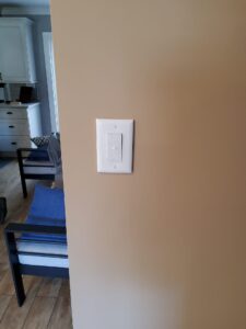 Deshaies Electrical Services installing a new light switch for the living room lighting upgrade project