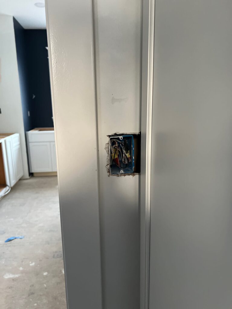 Deshaies Electrical Services installing an electrical outlet box as part of the house trim out completion