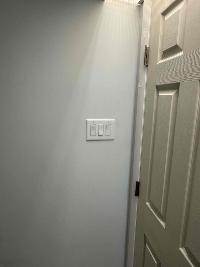 Deshaies Electrical Services installing and testing light switches for a comprehensive electrical installation project