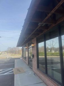 Deshaies Electrical Services modifying the soffit for recessed light installation