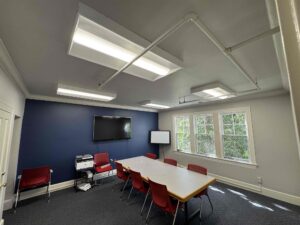 Deshaies Electrical Services performing an electrical lighting retrofit installation in a conference room