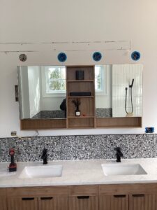Deshaies Electrical Services preparing for lighting installation above the bathroom vanity during an electrical trim out project